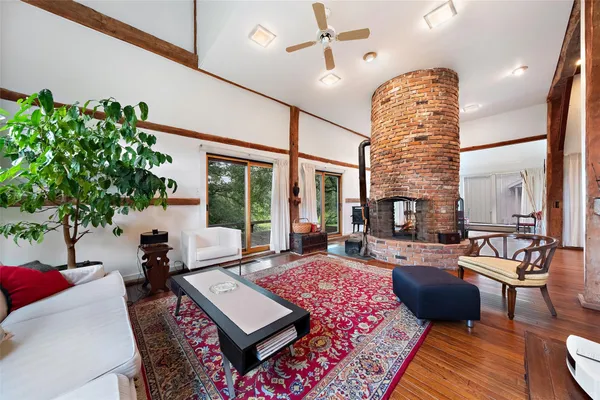 a living room with patio furniture and a potted plant