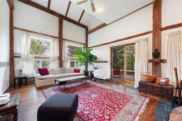 a living room with furniture a rug and a large window