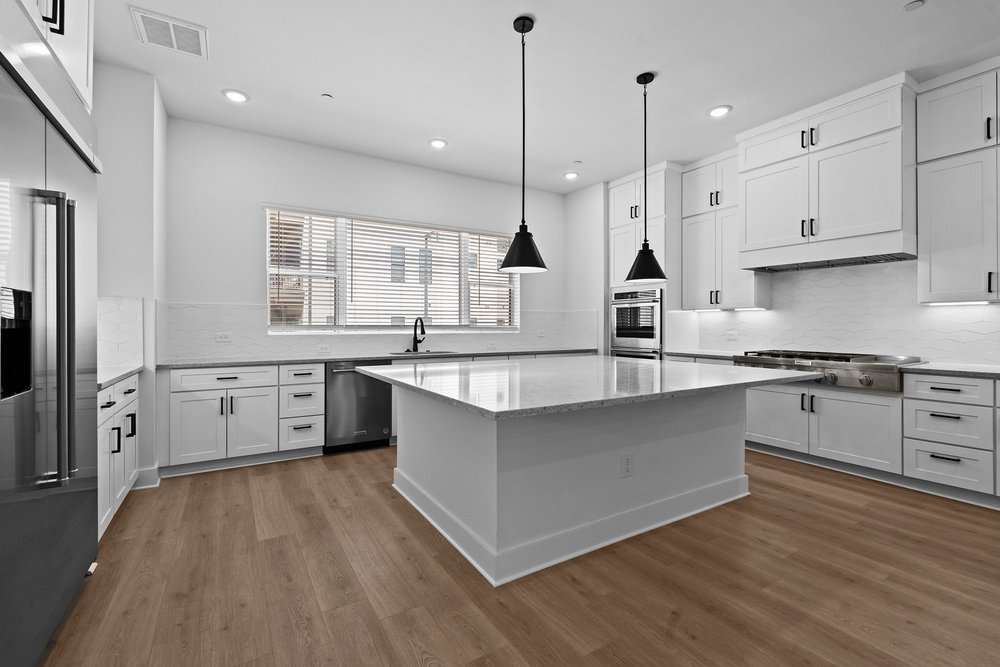 4309 Prevail Lane, Unit 18 Austin, TX 78731 - Photo 26 of 40 a large kitchen with stainless steel appliances a large counter top a sink a window and cabinets