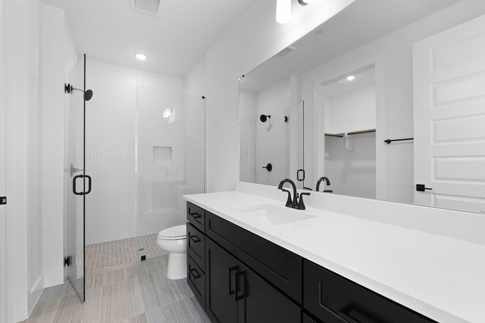 4309 Prevail Lane, Unit 18 Austin, TX 78731 - Photo 29 of 40 a bathroom with a sink a toilet a mirror and shower