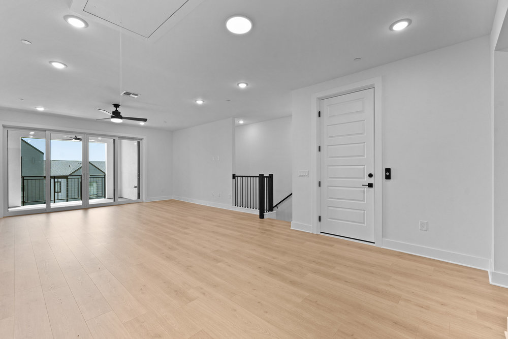 4309 Prevail Lane, Unit 18 Austin, TX 78731 - Photo 32 of 40 an empty room with wooden floor and windows