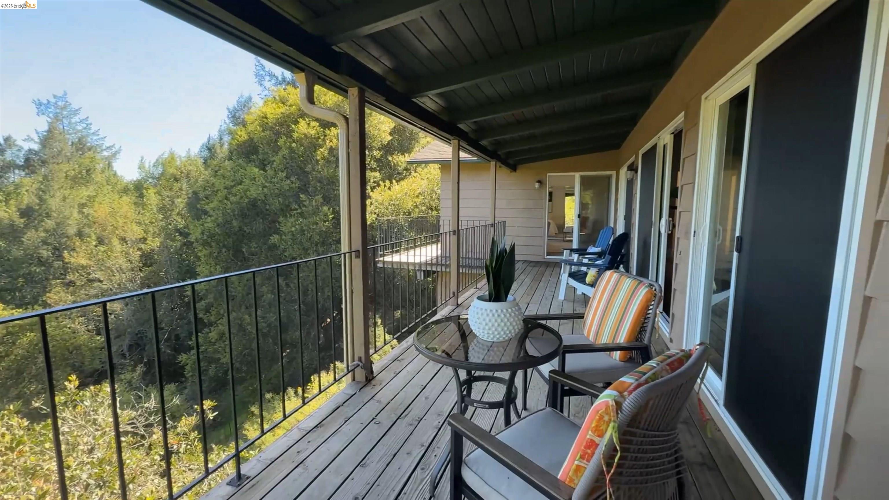 5051 Harrison Grade Road Sebastopol, CA 95472 - Photo 15 of 31 a balcony with chairs and wooden floor