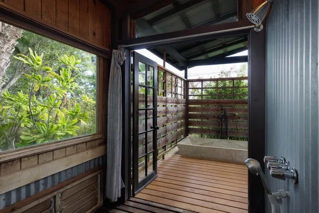 a room with a wooden floor and a large window