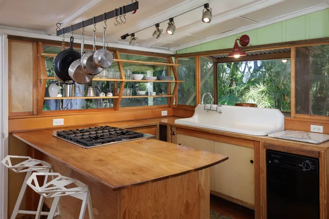 a kitchen with a stove a sink and a table