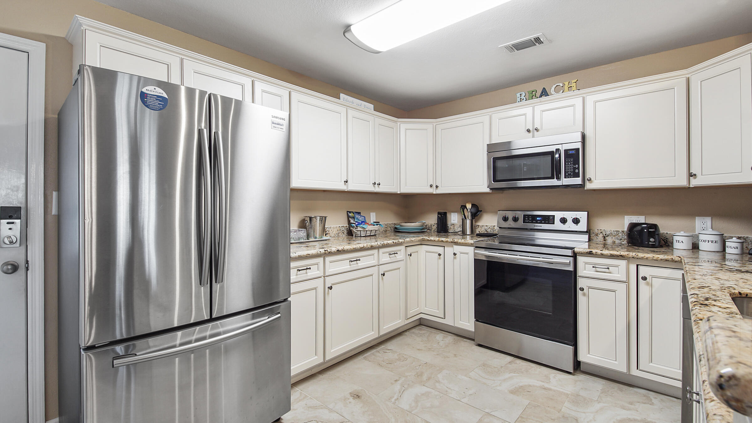 241 Ellis Road, Unit 51 Miramar Beach, FL 32550 - Photo 2 of 34 a kitchen with stainless steel appliances granite countertop a refrigerator sink and stove