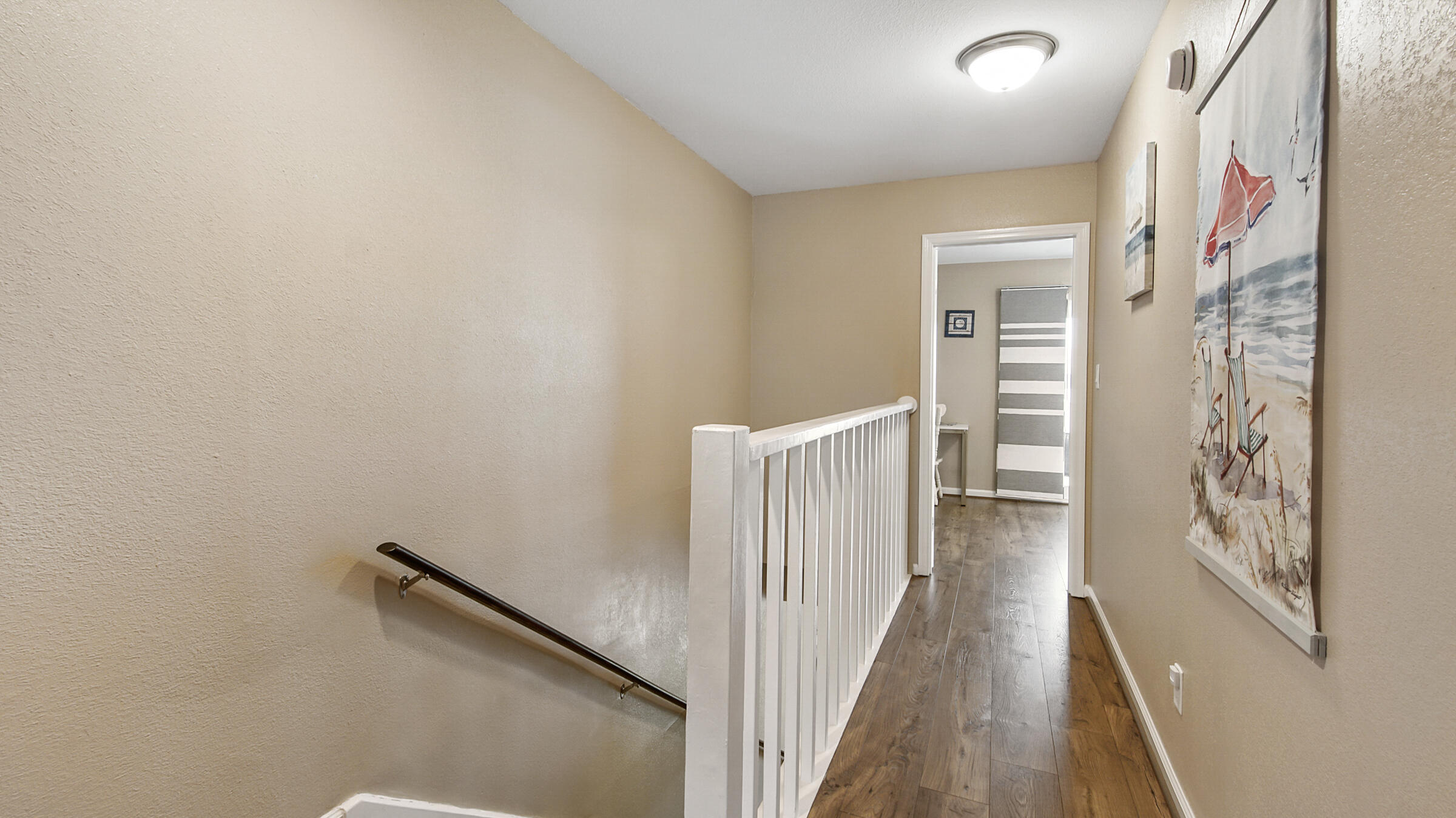 241 Ellis Road, Unit 51 Miramar Beach, FL 32550 - Photo 11 of 34 a view of a hallway with wooden floor