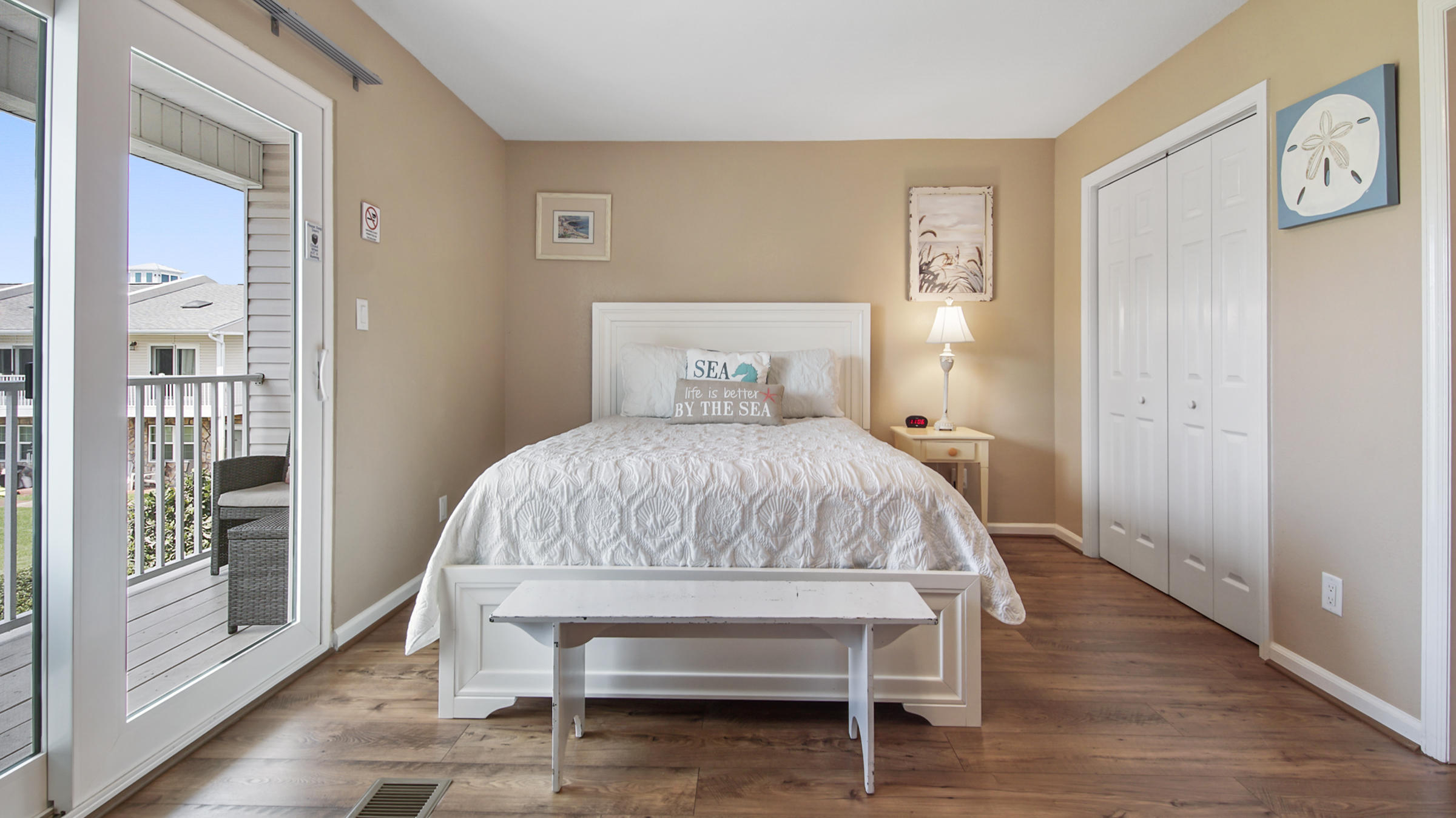 241 Ellis Road, Unit 51 Miramar Beach, FL 32550 - Photo 17 of 34 a bedroom with a bed and wooden floor