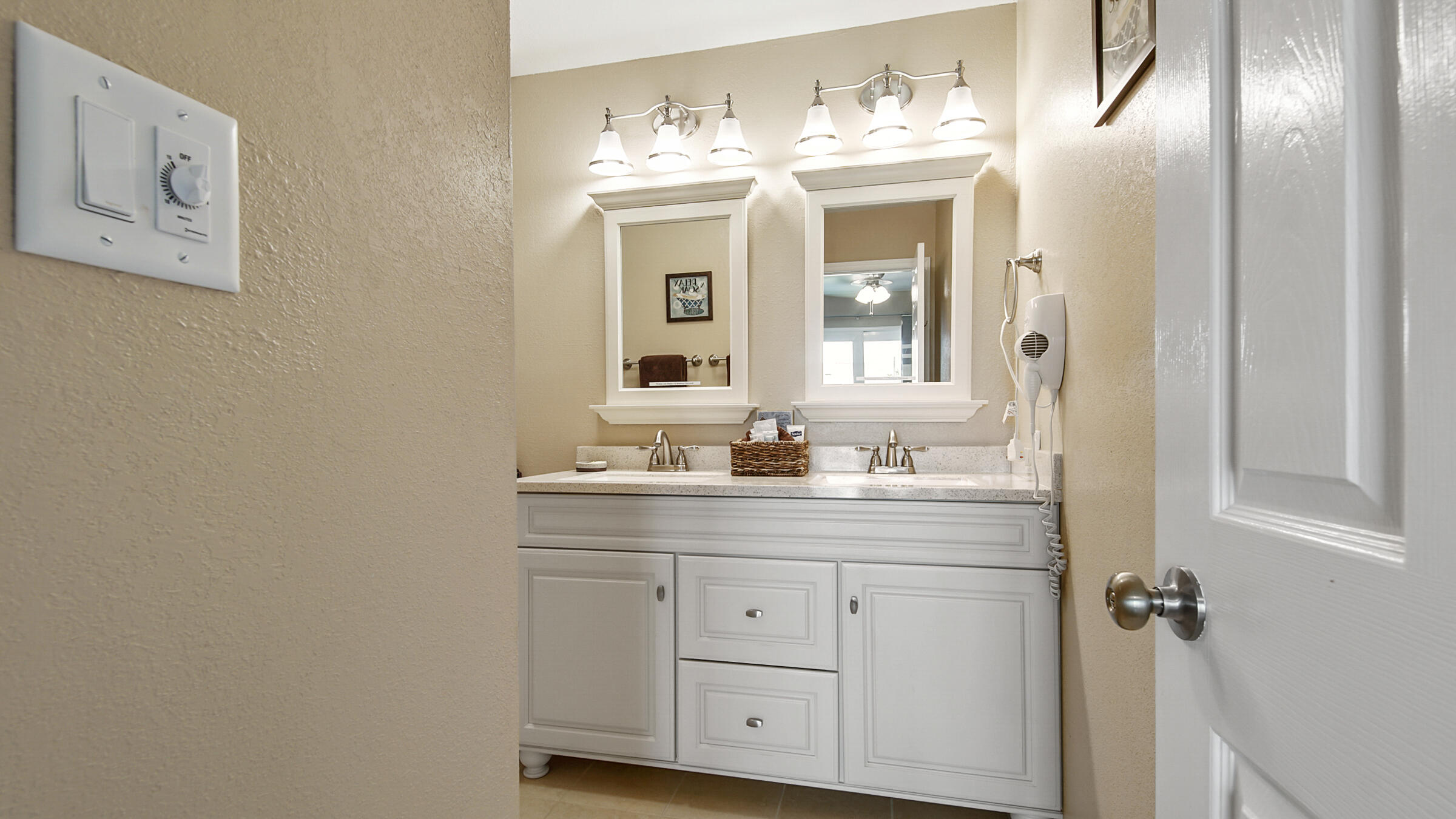 241 Ellis Road, Unit 51 Miramar Beach, FL 32550 - Photo 20 of 34 a bathroom with a double vanity sink and a mirror