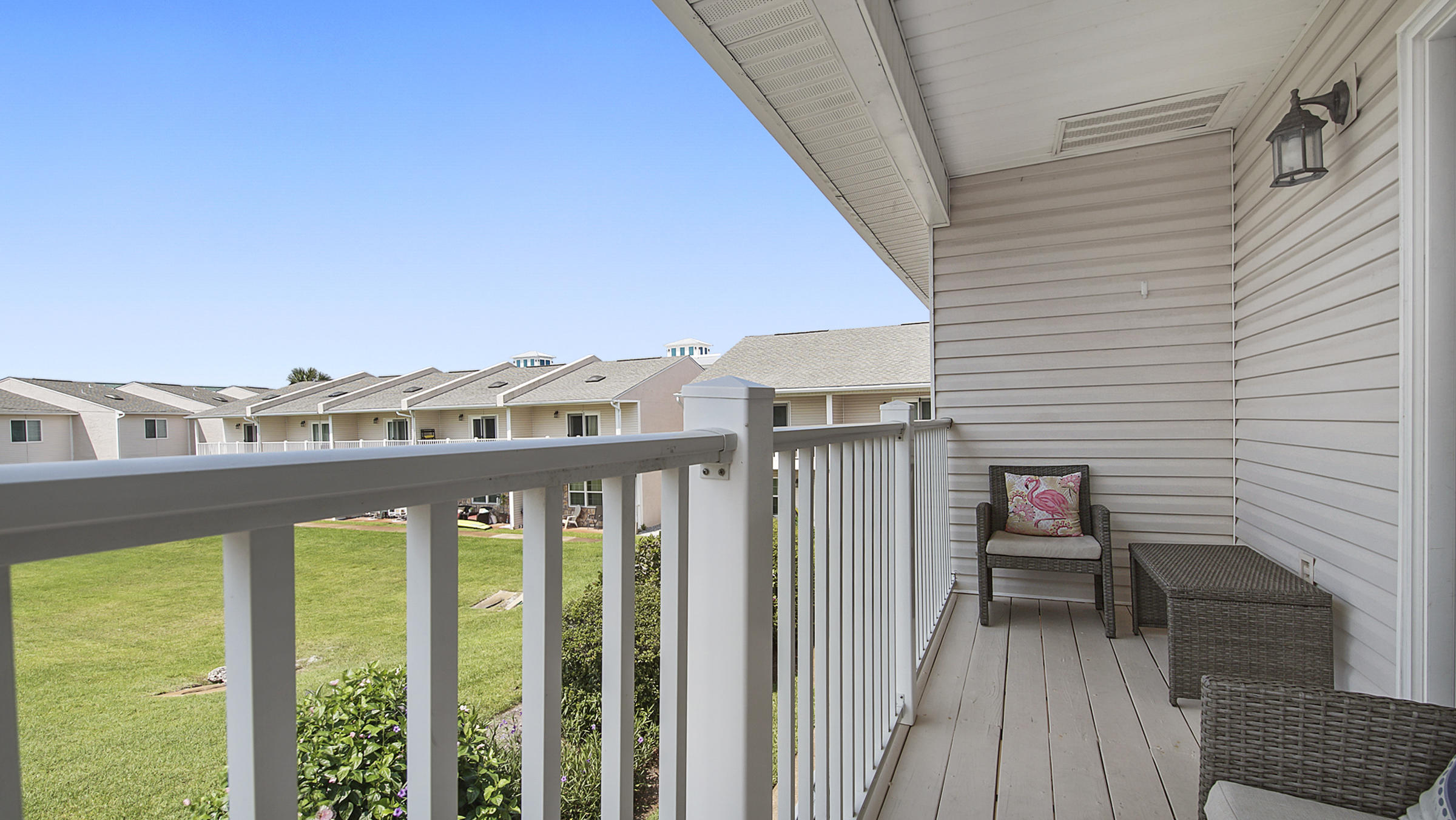 241 Ellis Road, Unit 51 Miramar Beach, FL 32550 - Photo 21 of 34 a view of a balcony with chairs and wooden floor