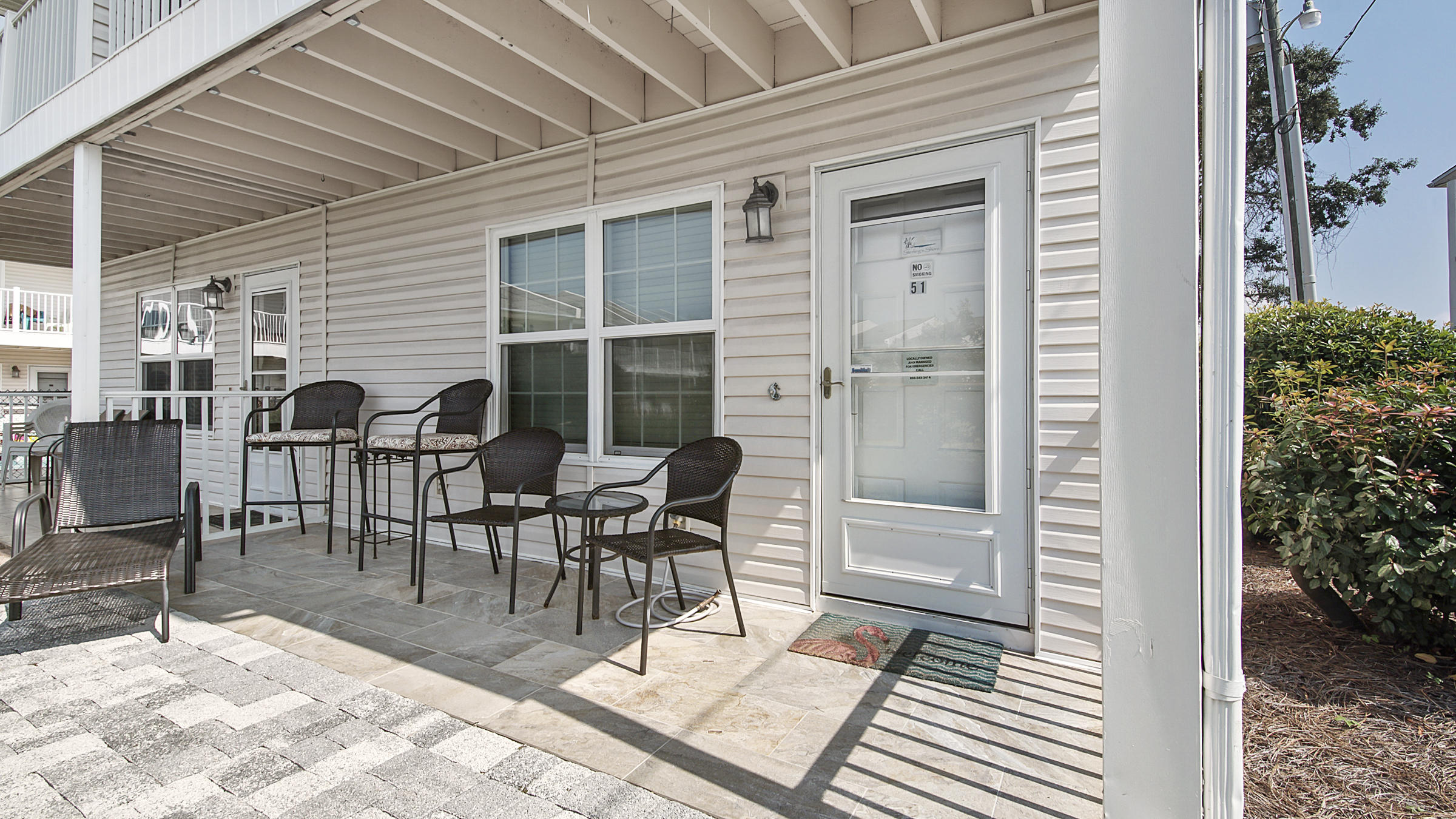 241 Ellis Road, Unit 51 Miramar Beach, FL 32550 - Photo 23 of 34 a view of a patio with table and chairs and potted plants