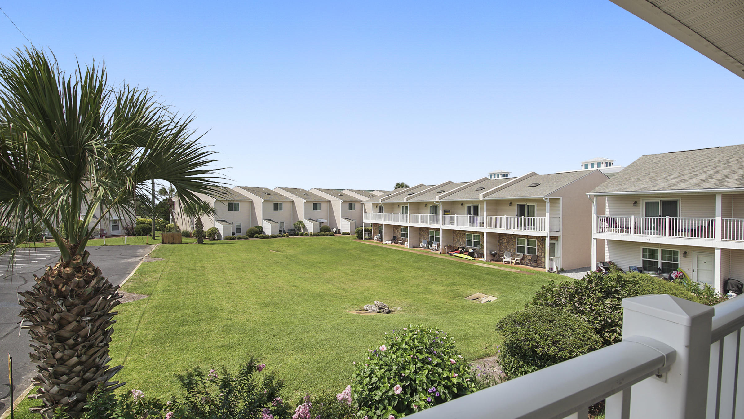 241 Ellis Road, Unit 51 Miramar Beach, FL 32550 - Photo 24 of 34 a front view of a house with a garden