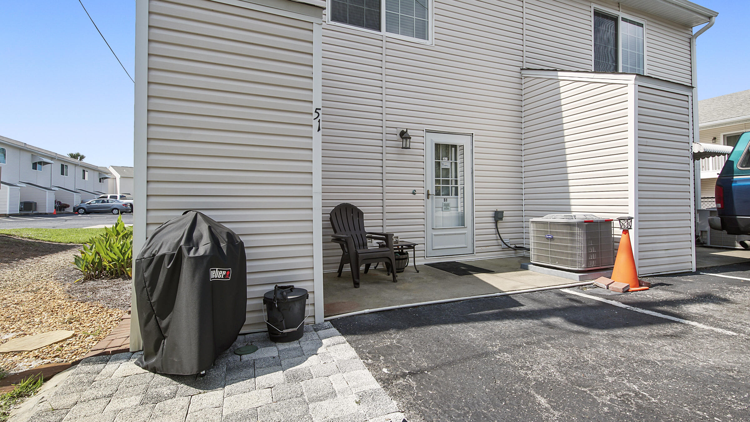 241 Ellis Road, Unit 51 Miramar Beach, FL 32550 - Photo 26 of 34 a view of a chairs and table in the back yard
