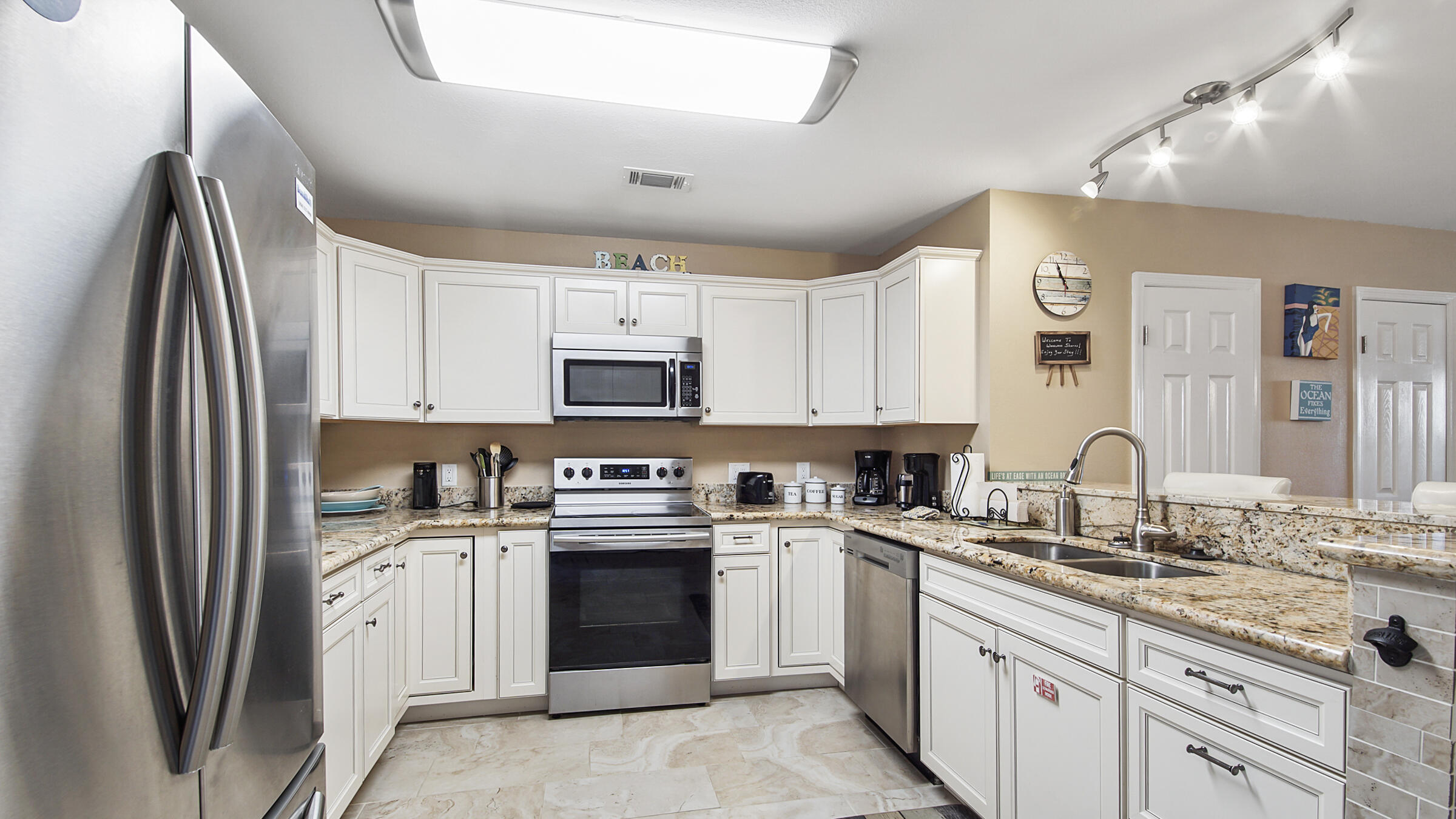 241 Ellis Road, Unit 51 Miramar Beach, FL 32550 - Photo 4 of 34 a kitchen with stainless steel appliances granite countertop a sink stove and refrigerator