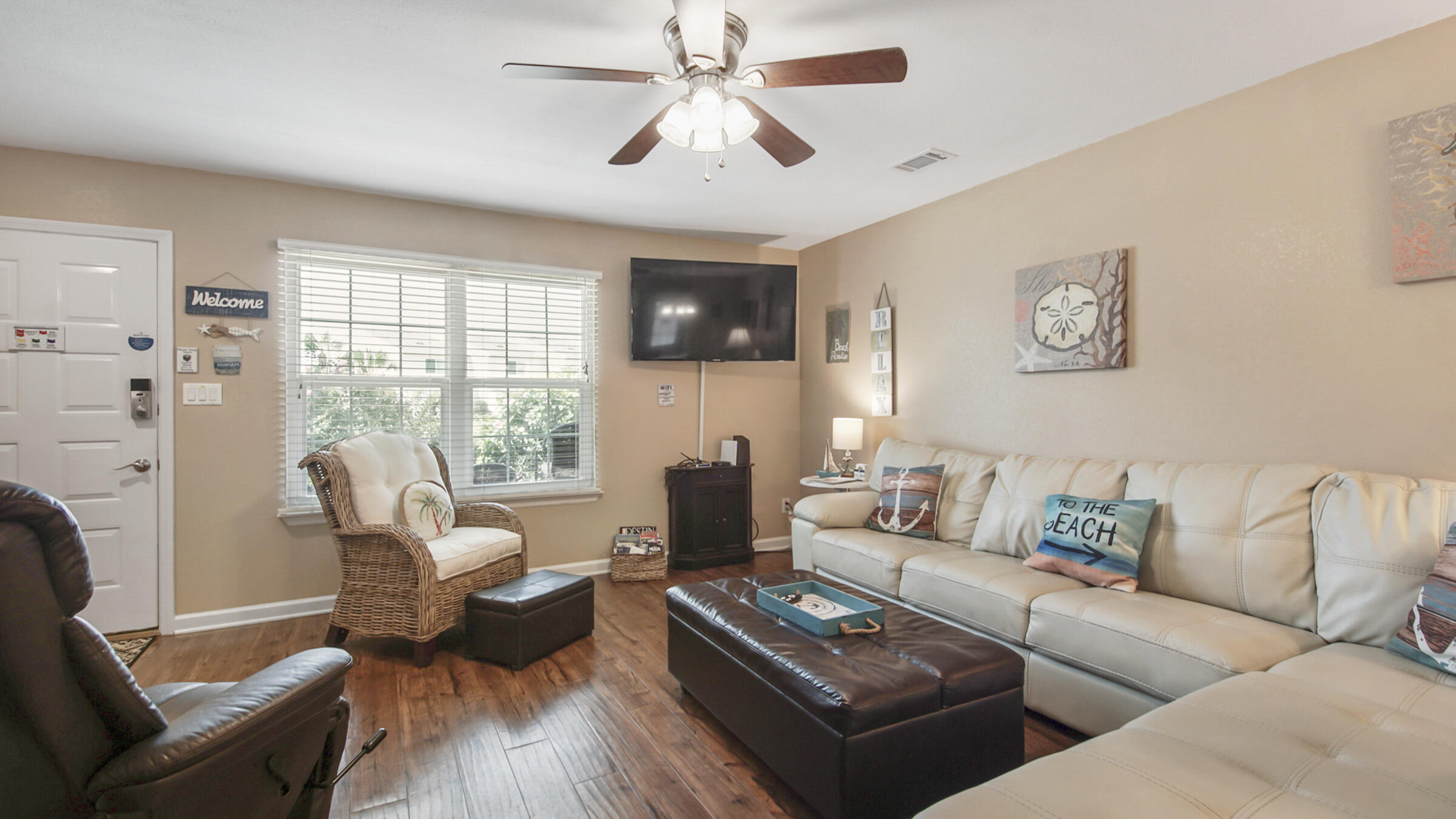 241 Ellis Road, Unit 51 Miramar Beach, FL 32550 - Photo 8 of 34 a living room with furniture and a flat screen tv