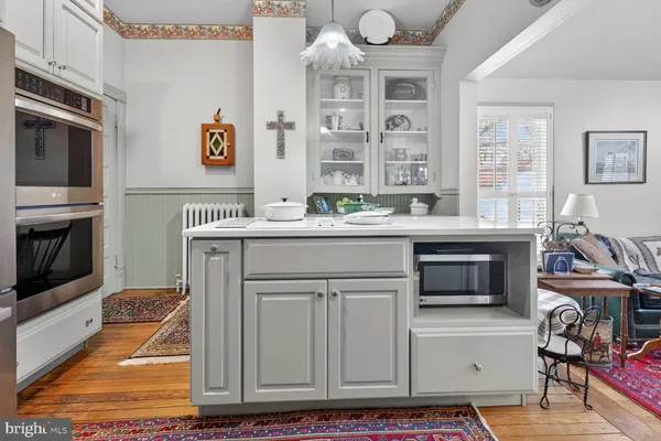 a kitchen with granite countertop a refrigerator and a stove top oven
