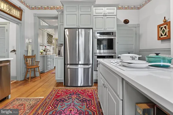 a view of a kitchen with sink cabinets and wooden floor