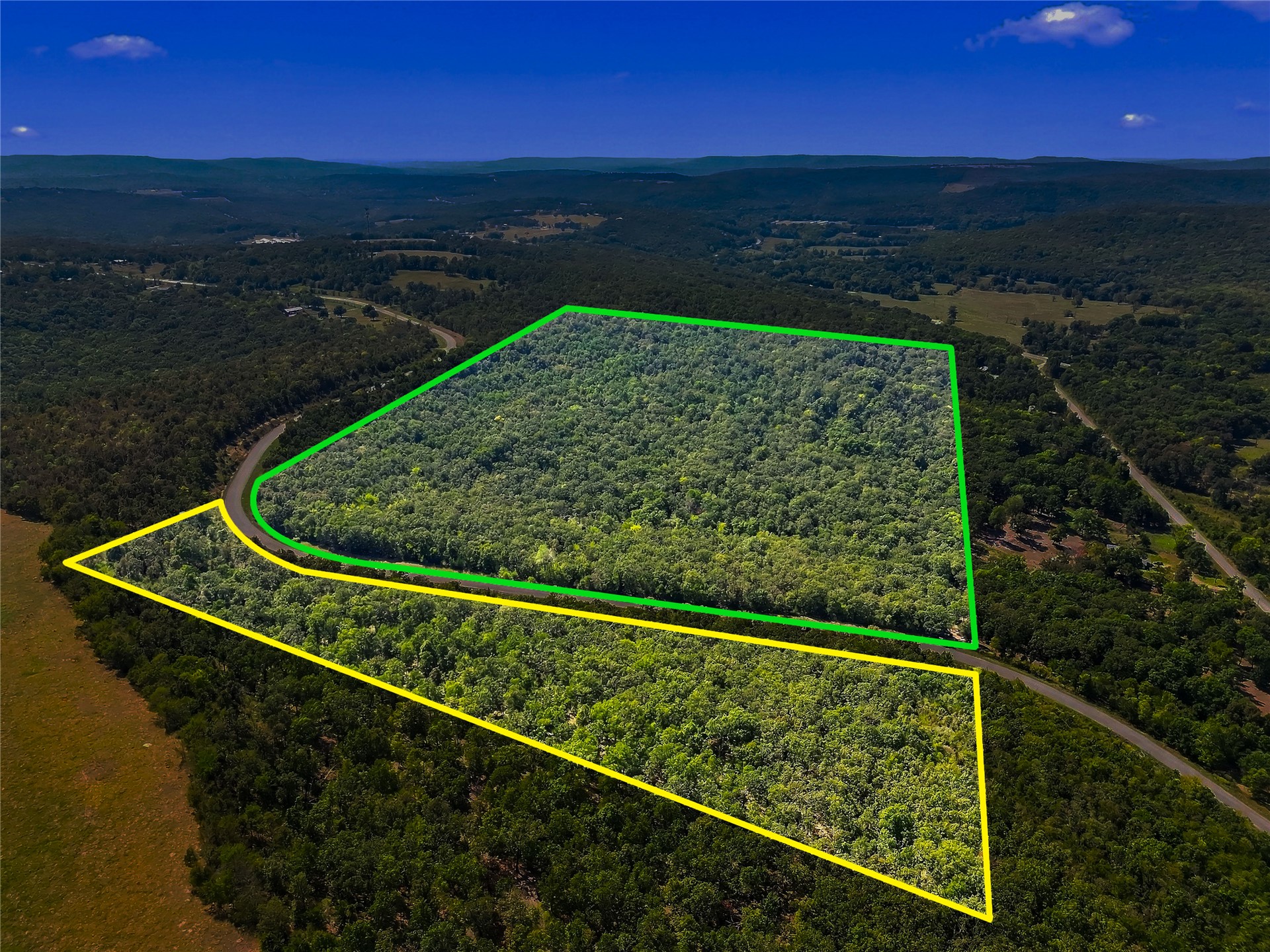 90333 South 4697 Road Stilwell, OK 74960 - Photo 3 of 26 Expansive wooded land featuring a curved road frontage and distant mountain scenery