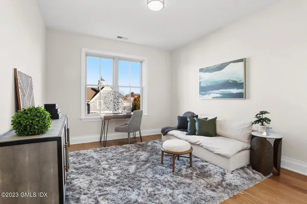 a living room with furniture potted plant and a window