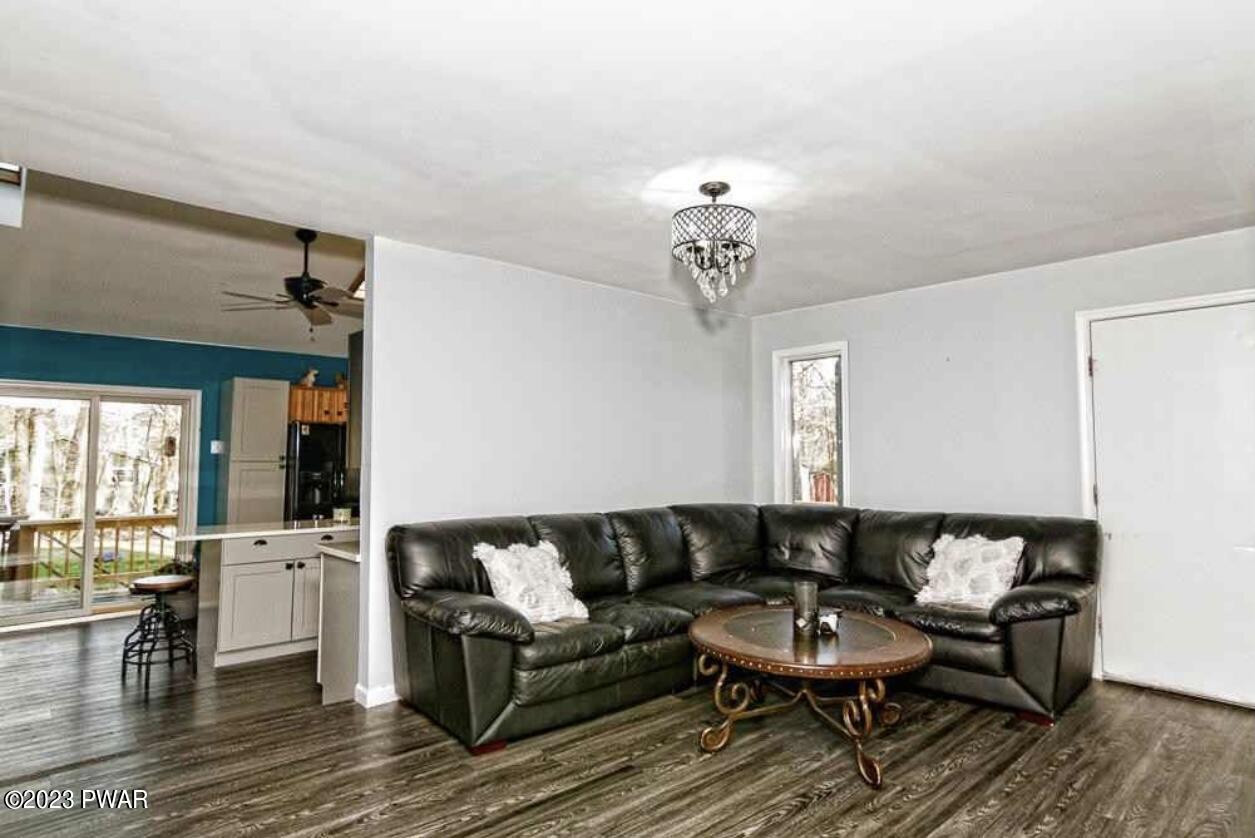 146 Roundhill Road Dingmans Ferry, PA 18328 - Photo 9 of 53 a living room with furniture and wooden floor