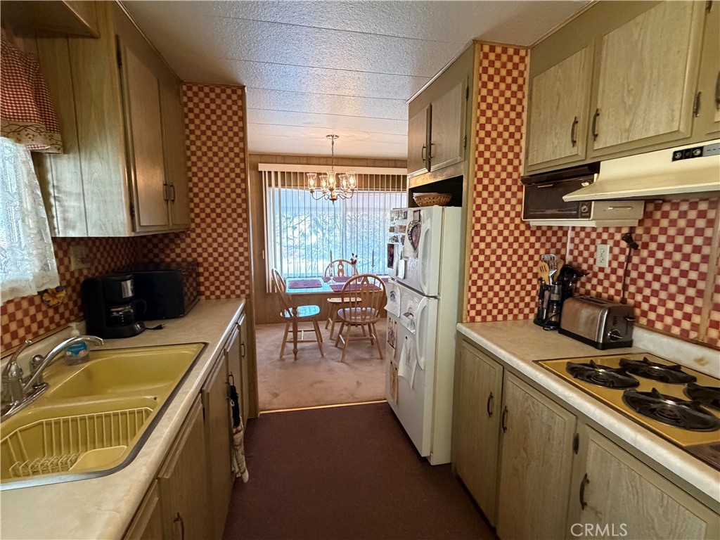 3701 Fillmore Street, Unit 64 Riverside, CA 92505 - Photo 13 of 26 a kitchen that has a sink and a stove