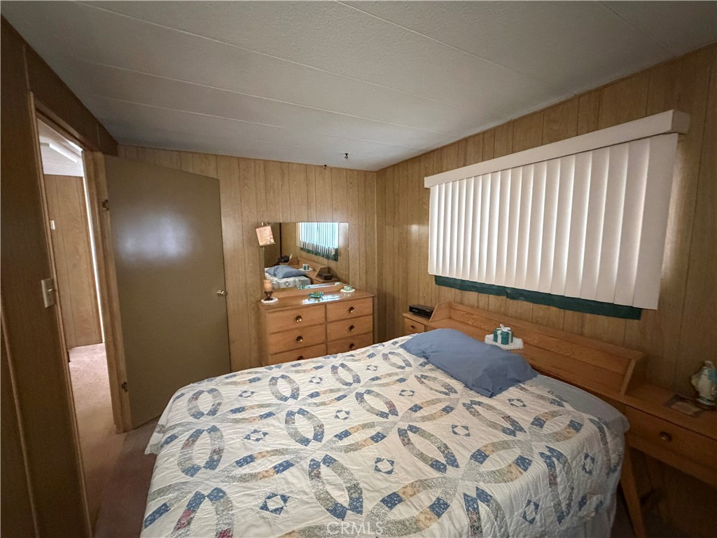 3701 Fillmore Street, Unit 64 Riverside, CA 92505 - Photo 19 of 26 a bedroom with a bed and a dresser