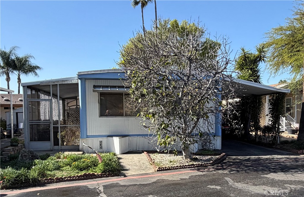 3701 Fillmore Street, Unit 64 Riverside, CA 92505 - Photo 2 of 26 a front view of a house with a yard