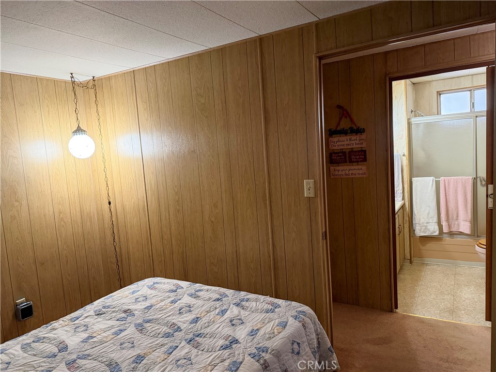 3701 Fillmore Street, Unit 64 Riverside, CA 92505 - Photo 24 of 26 a bedroom with a bed and a shower