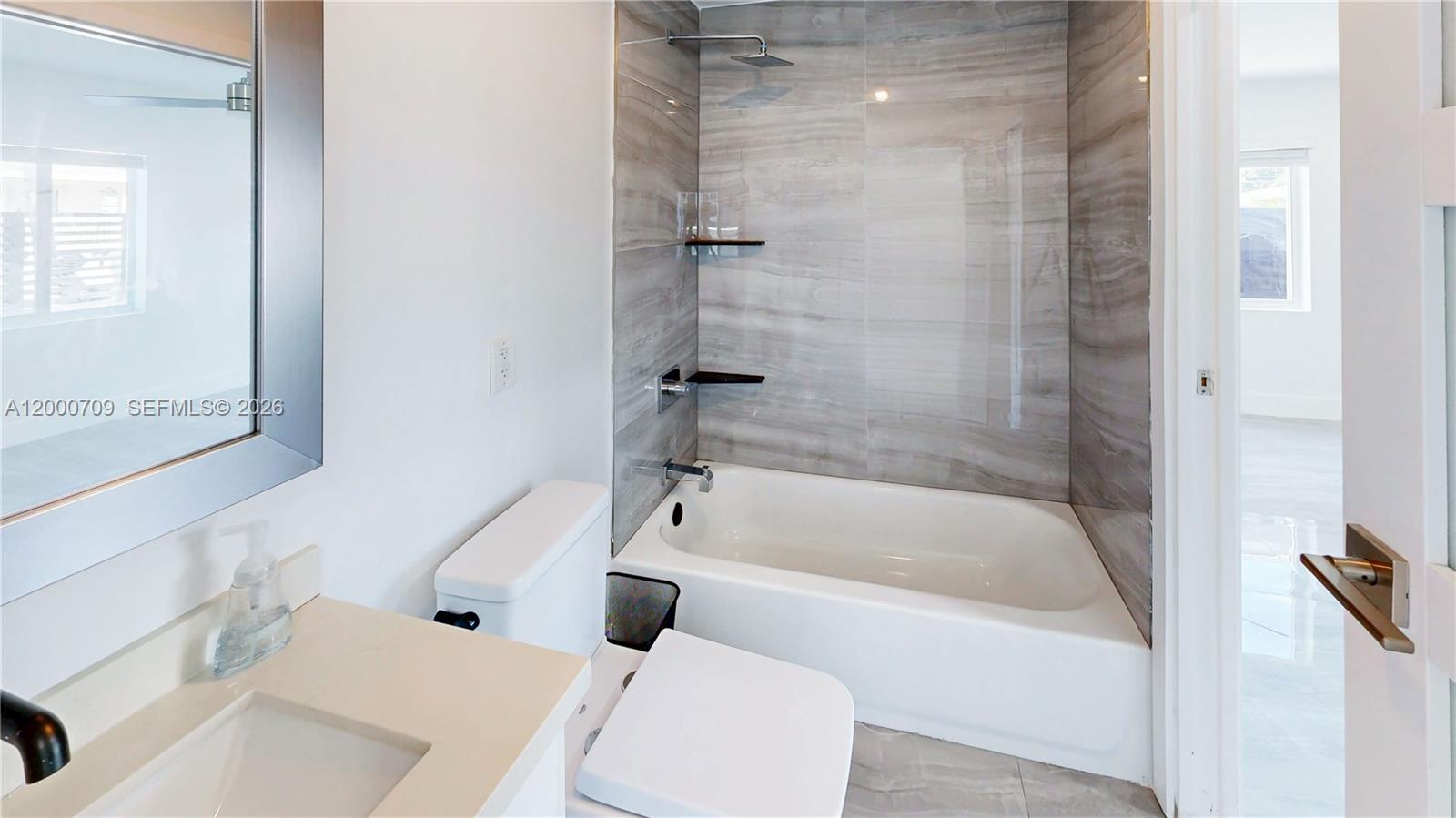 1886 Northwest 68th Street Miami, FL 33147 - Photo 19 of 56 a white bath tub sitting next to a white toilet