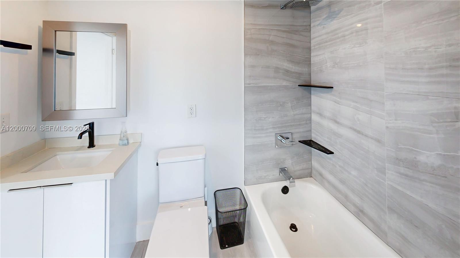 1886 Northwest 68th Street Miami, FL 33147 - Photo 20 of 56 a bathroom with a sink a toilet and shower
