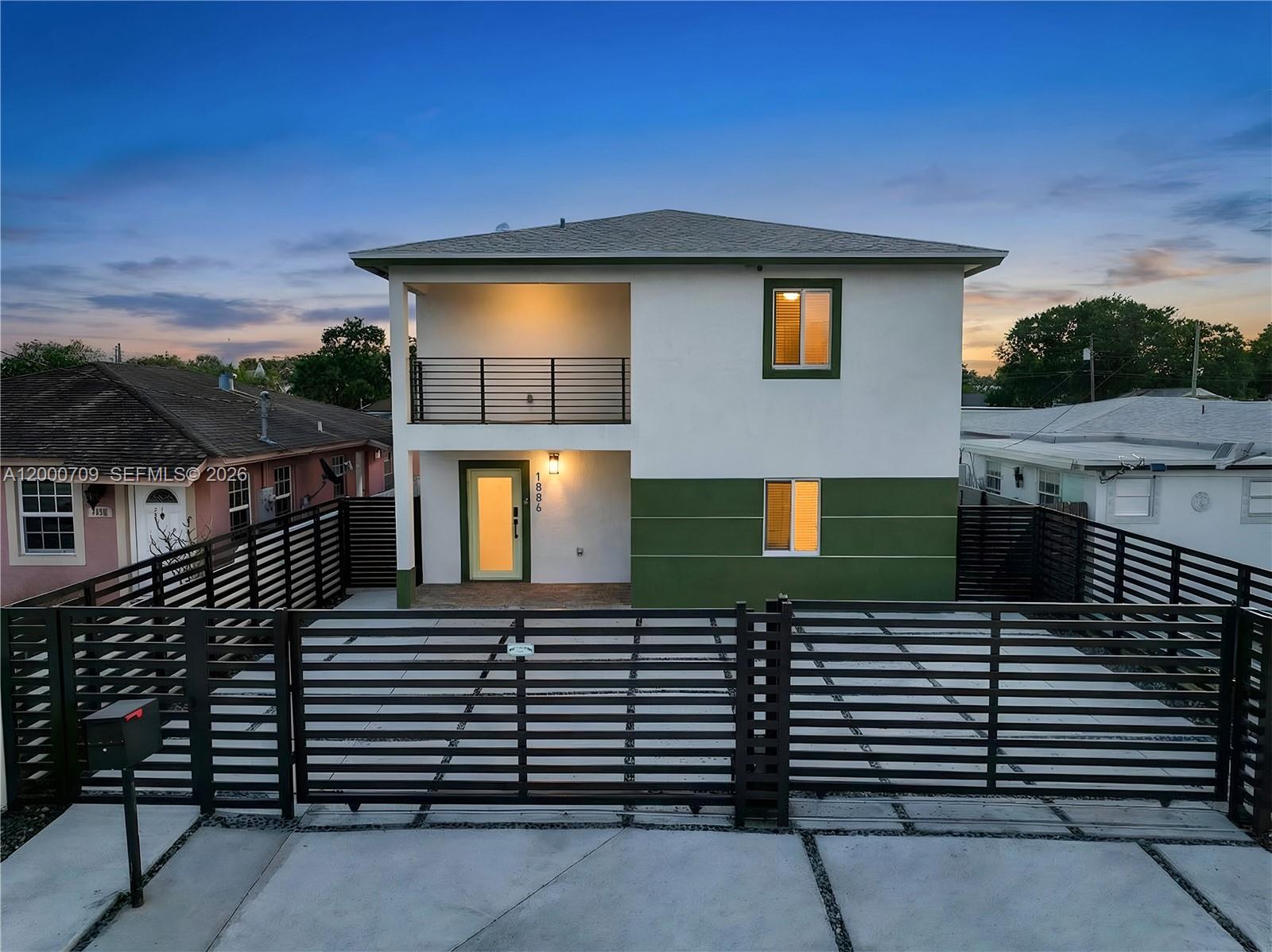 1886 Northwest 68th Street Miami, FL 33147 - Photo 2 of 56 a front view of a house with a yard