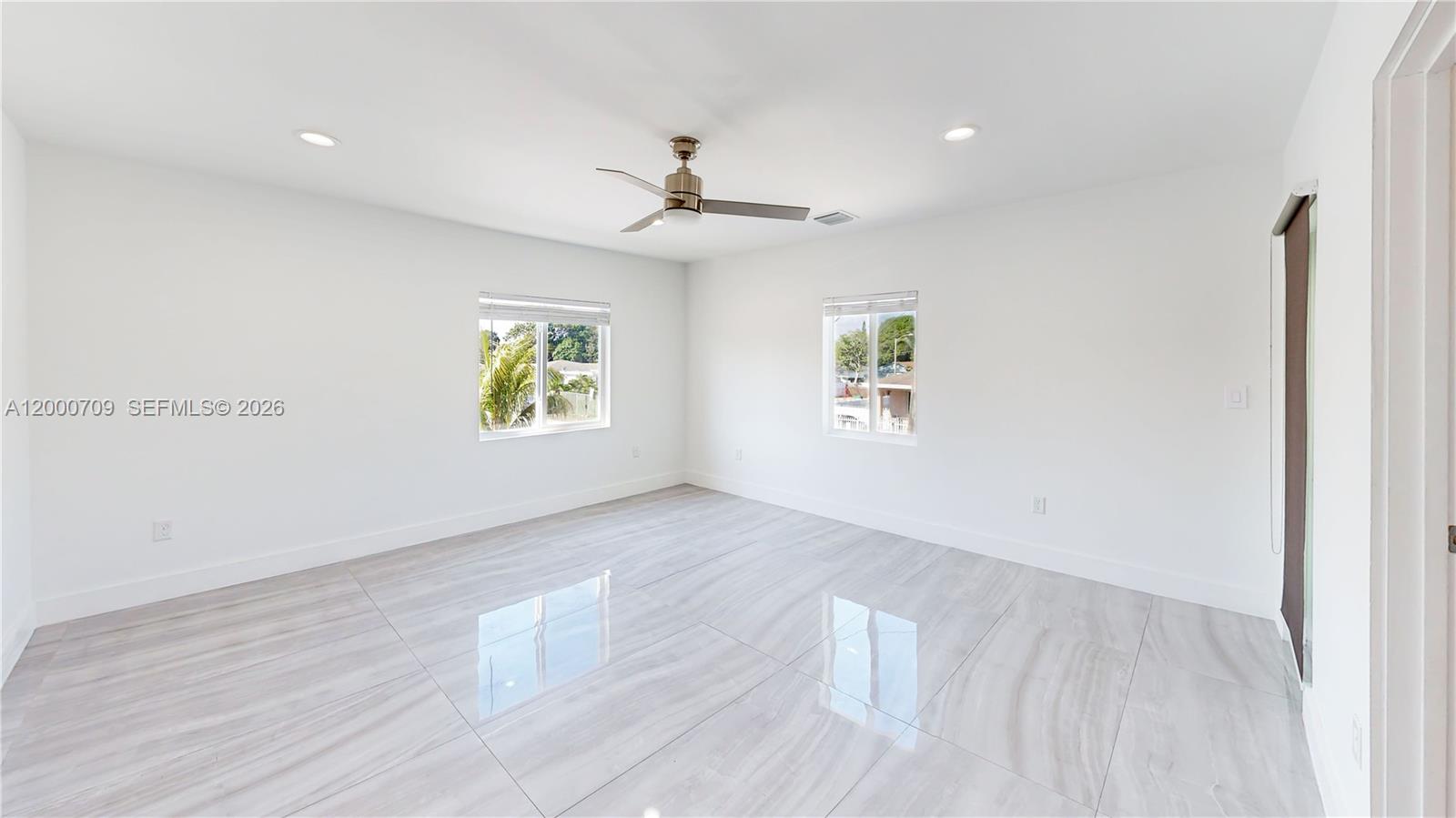 1886 Northwest 68th Street Miami, FL 33147 - Photo 23 of 56 wooden floor in an empty room with a window