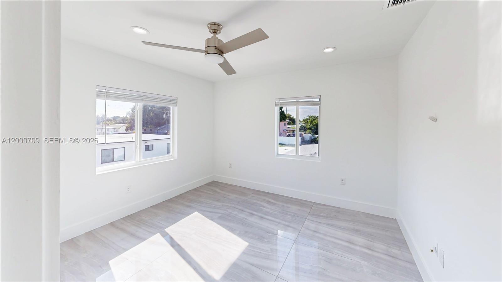 1886 Northwest 68th Street Miami, FL 33147 - Photo 27 of 56 an empty room with windows and fan