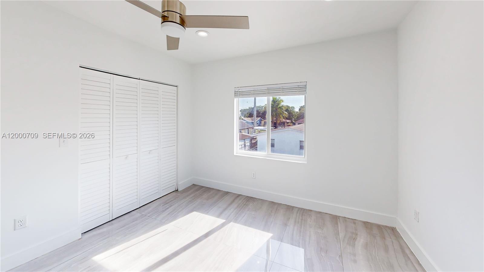 1886 Northwest 68th Street Miami, FL 33147 - Photo 29 of 56 an empty room with a window