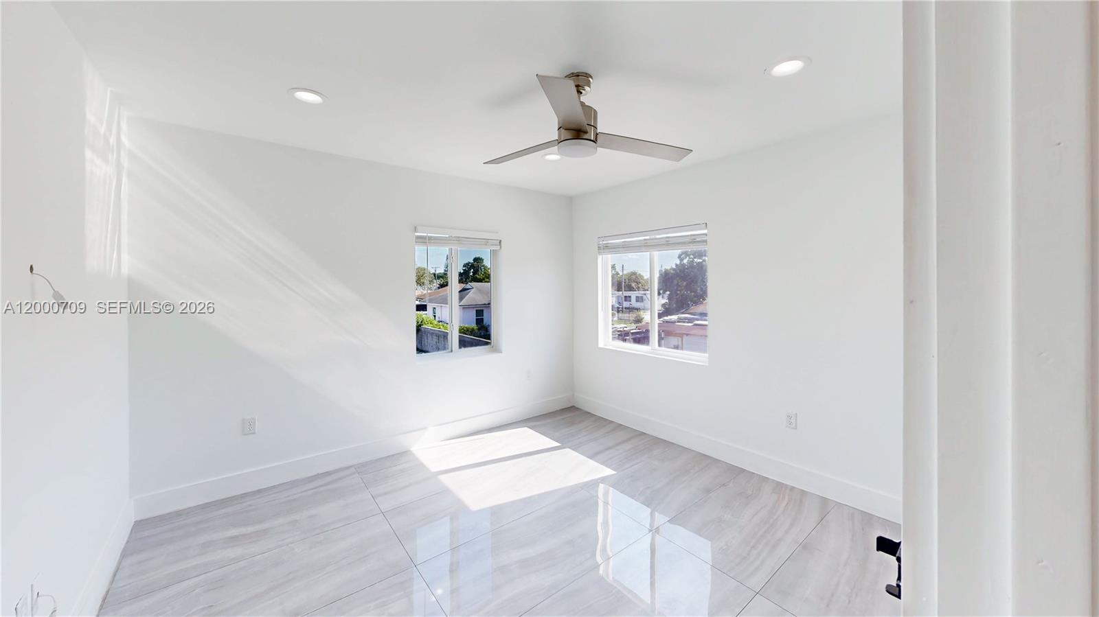 1886 Northwest 68th Street Miami, FL 33147 - Photo 31 of 56 wooden floor in an empty room with a window