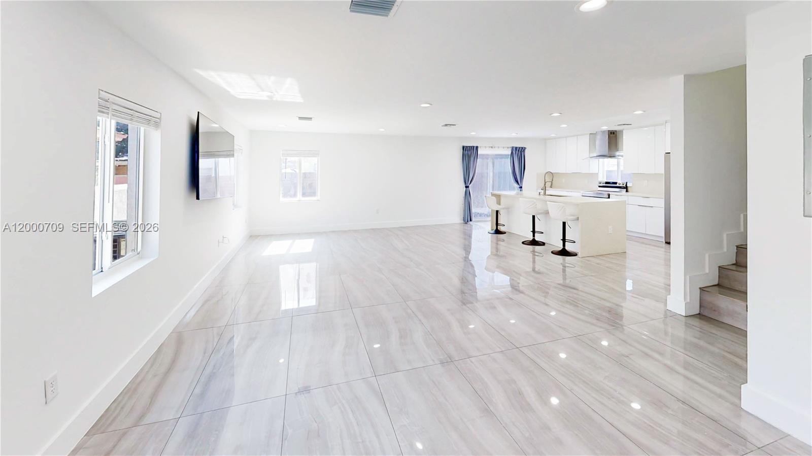 1886 Northwest 68th Street Miami, FL 33147 - Photo 5 of 56 a view of a living room hardwood floor and a kitchen