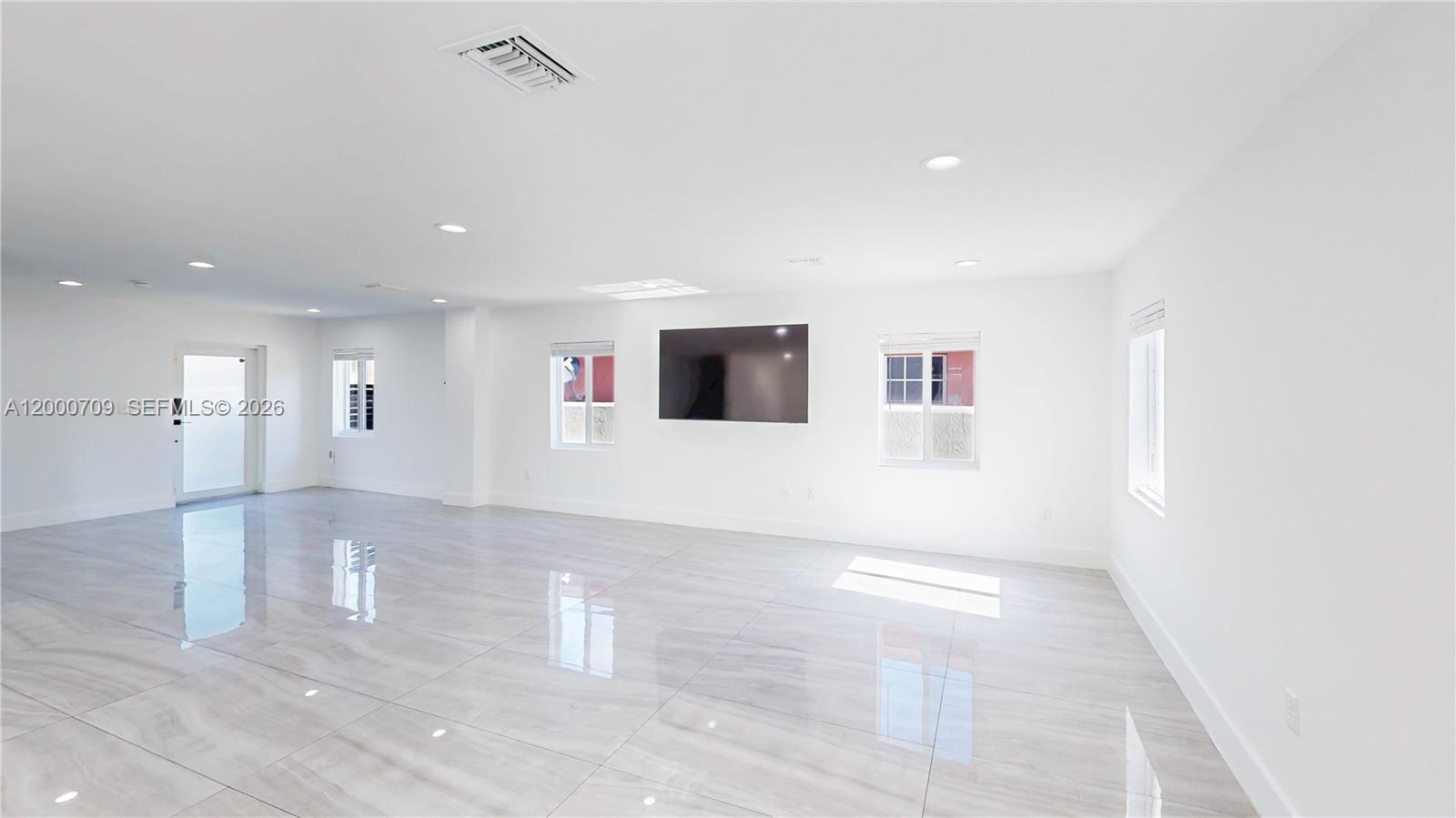 1886 Northwest 68th Street Miami, FL 33147 - Photo 8 of 56 a view of a projector room with a ceiling fan