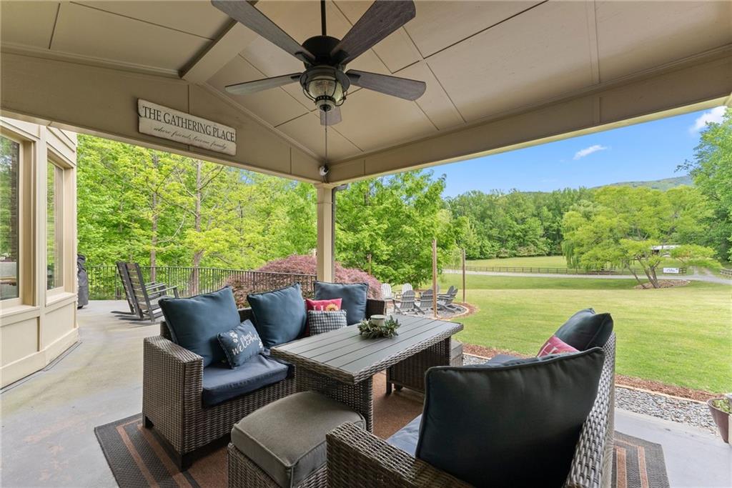 253 Happy Trails Way Jasper, GA 30143 - Photo 75 of 97 a living room with patio furniture and a floor to ceiling window
