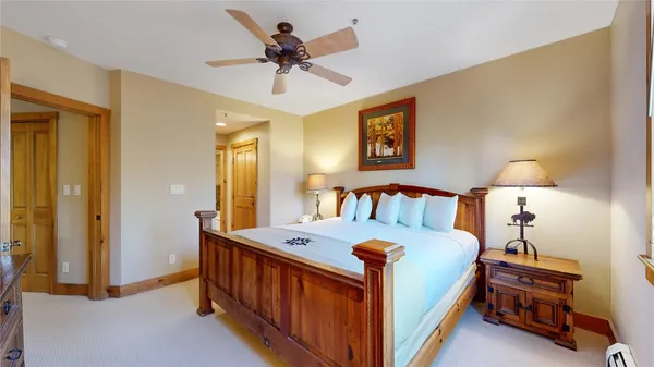 a bedroom with a bed and a chandelier