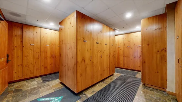 a living room with furniture a flat screen tv and floor to ceiling window