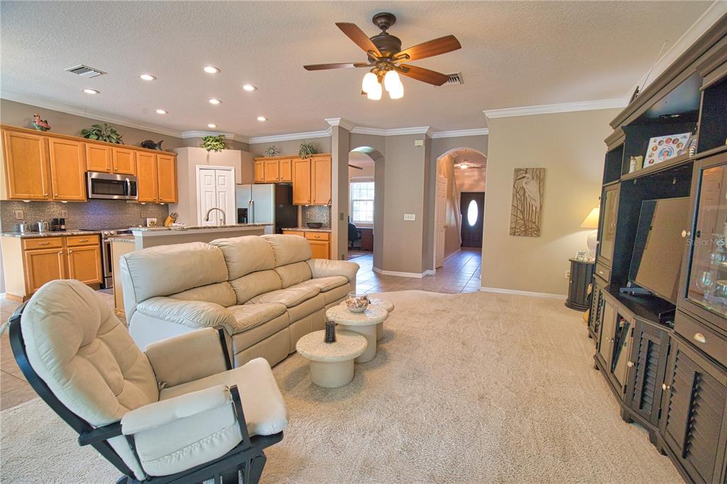 5288 Layton Drive Venice, FL 34293 - Photo 11 of 75 a living room with furniture a ceiling fan and a flat screen tv