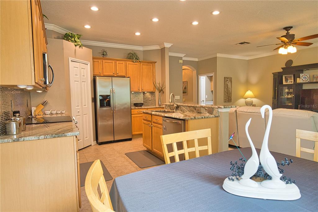 5288 Layton Drive Venice, FL 34293 - Photo 18 of 75 a kitchen with stainless steel appliances kitchen island granite countertop a refrigerator and a sink