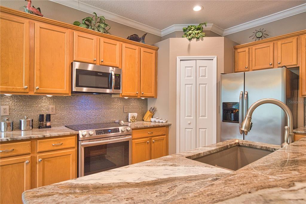 5288 Layton Drive Venice, FL 34293 - Photo 21 of 75 a kitchen with stainless steel appliances granite countertop a stove a sink dishwasher and a microwave