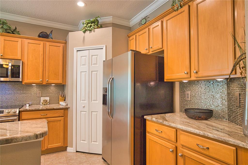 5288 Layton Drive Venice, FL 34293 - Photo 23 of 75 a kitchen with stainless steel appliances granite countertop a refrigerator and a sink