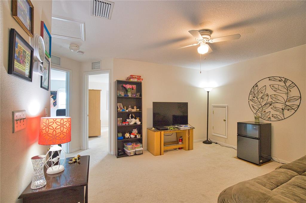5288 Layton Drive Venice, FL 34293 - Photo 42 of 75 a living room with furniture and a flat screen tv