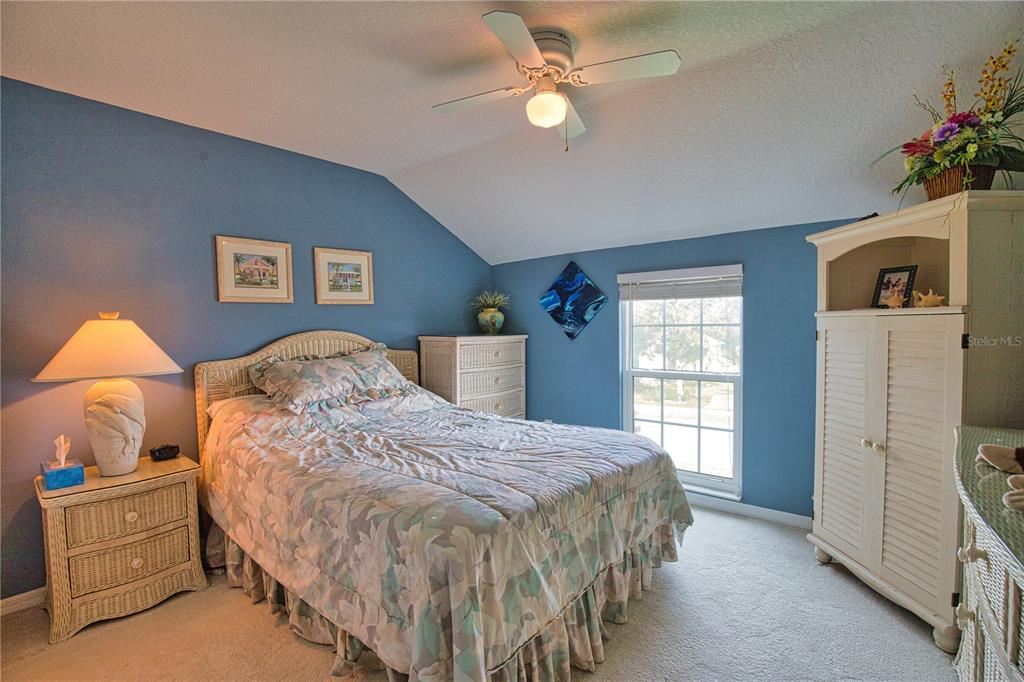 5288 Layton Drive Venice, FL 34293 - Photo 45 of 75 a bedroom with a bed and a chandelier