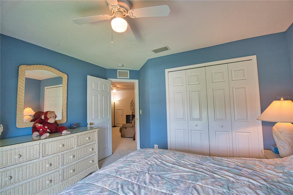5288 Layton Drive Venice, FL 34293 - Photo 46 of 75 a spacious bedroom with a large bed and a chandelier