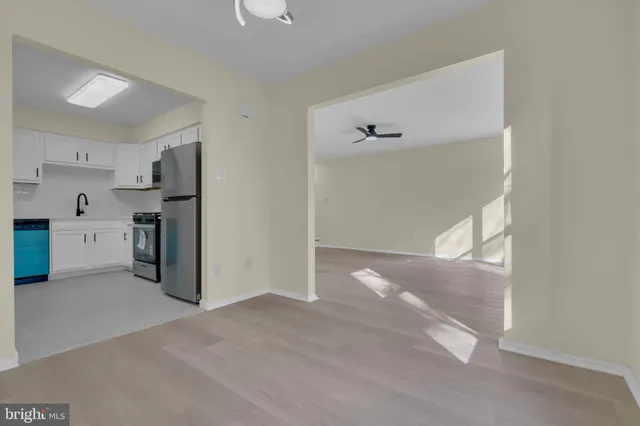 a view of a kitchen with a refrigerator a sink and a dishwasher