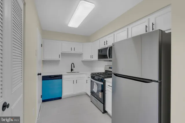 a kitchen with stainless steel appliances granite countertop a refrigerator stove a sink and dishwasher