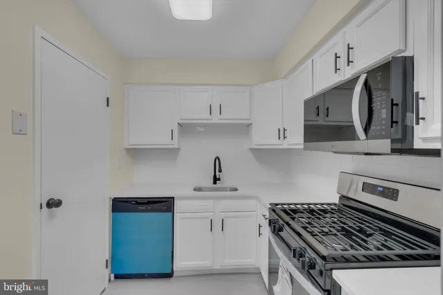 a kitchen with stainless steel appliances granite countertop a stove a sink dishwasher and a refrigerator