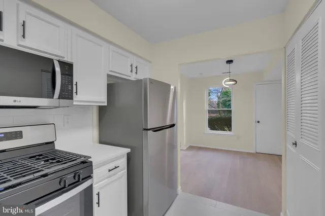 a kitchen with a stove and a refrigerator